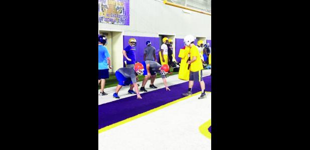 Delhi Charter School students Lawson Nelson and Austin Mahoney receive lineman instruction at the LSU 7-on-7 camp.